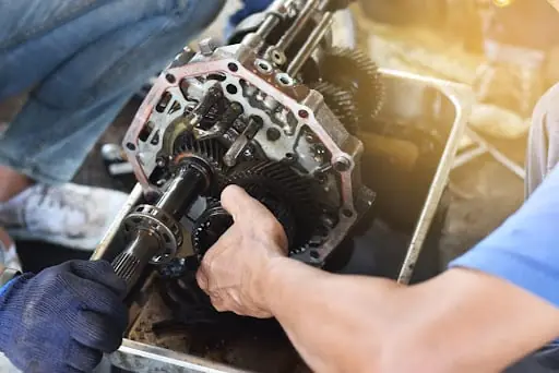 A car mechanic addressing a transmission that’s shifting hard.