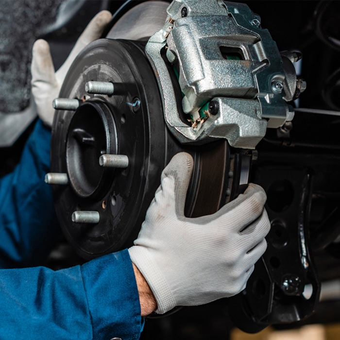 Autocare Pro's mechanic working on brakes.