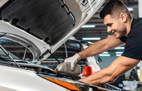 Autocare Pro's ASE-certified technician performing an oil change.